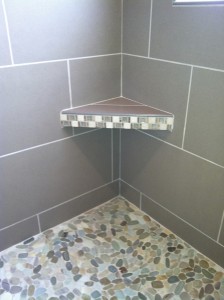 pebble-tile-shower-floor-with-shelf-and-large-format-tiles